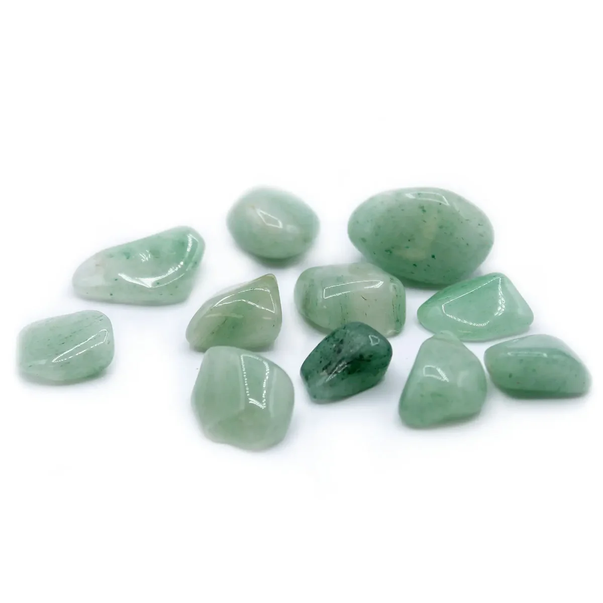 Assorted aventurine tumble stones in a clear glass bowl, showcasing emerald green hues, arranged neatly.