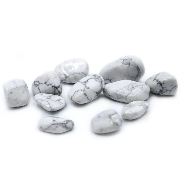 White howlite tumble stones arranged in a neat cluster on a neutral background