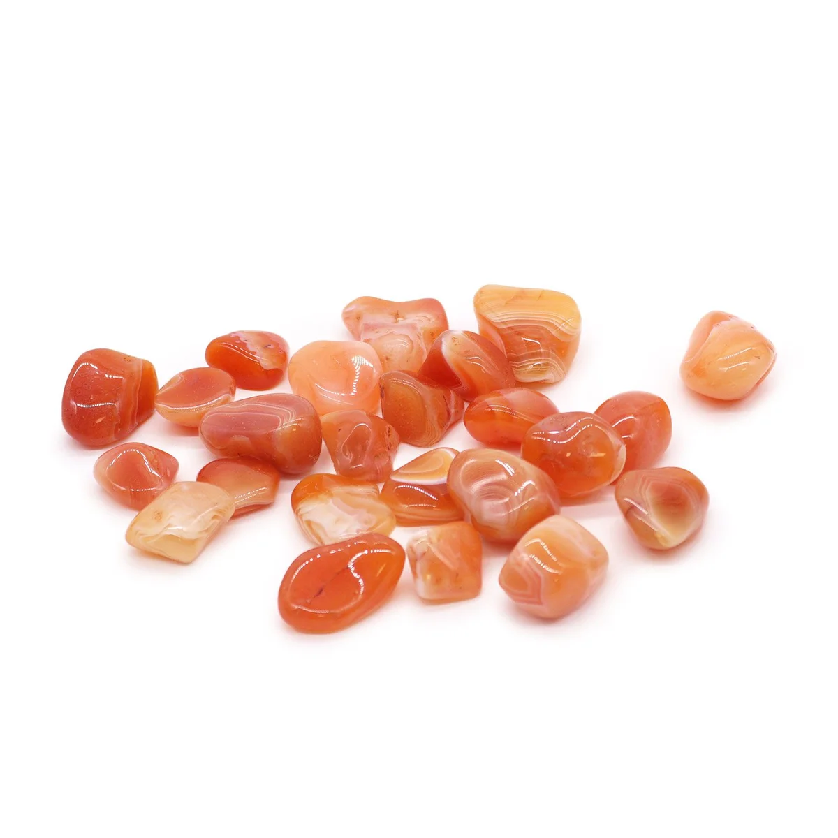 Carnelian tumble stone displayed alone.