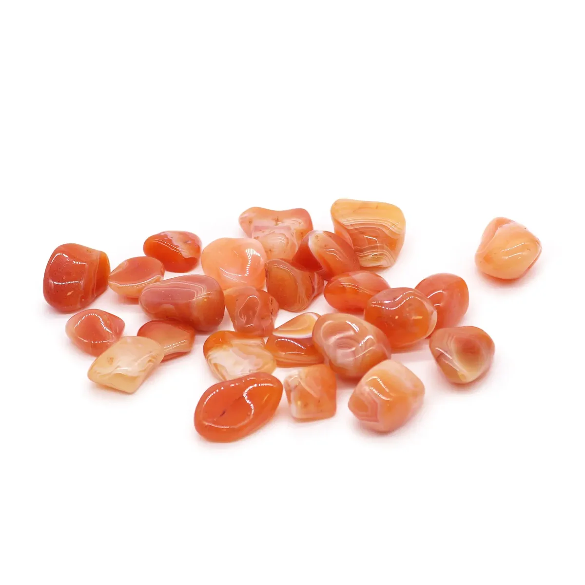 Set of tumbling carnelian stones in warm orange hues.