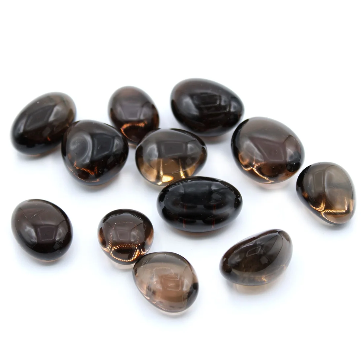 Assorted smoky quartz tumble stones displayed in a shallow bowl.