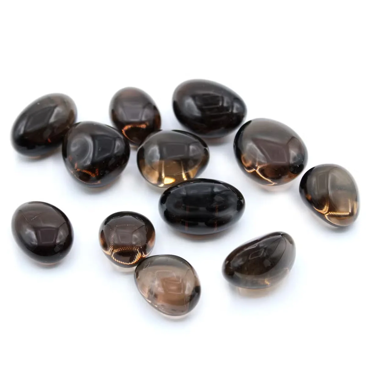 Smoky quartz tumble stones displayed in a clear glass jar, showcasing natural healing crystal stones.