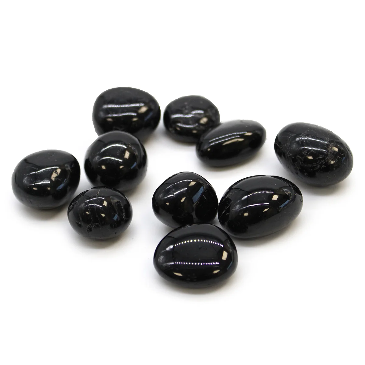 Black tourmaline tumble stones arranged as a decorative set, showcasing polished natural stones for tumble stones decor.