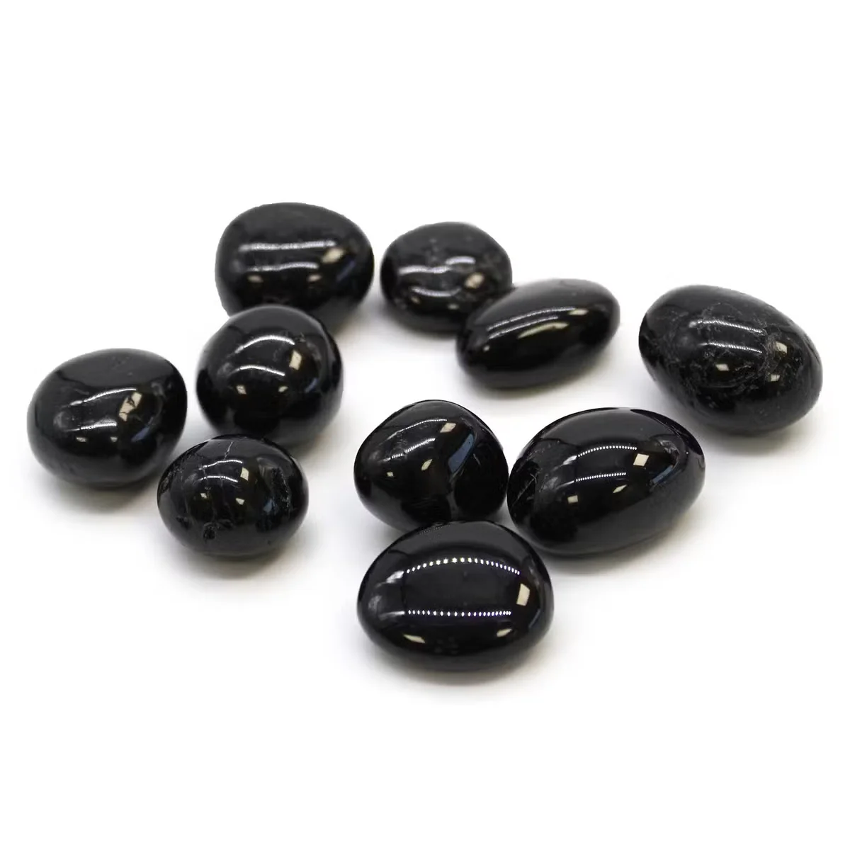 Healing crystal stones: black tourmaline tumble stones from L Tumble Stones, a set of black tourmaline crystals.