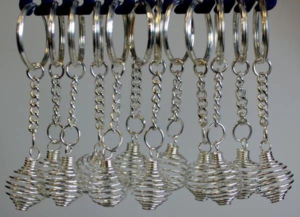 12 spiral cage novelty keyrings displayed in a neat arrangement.