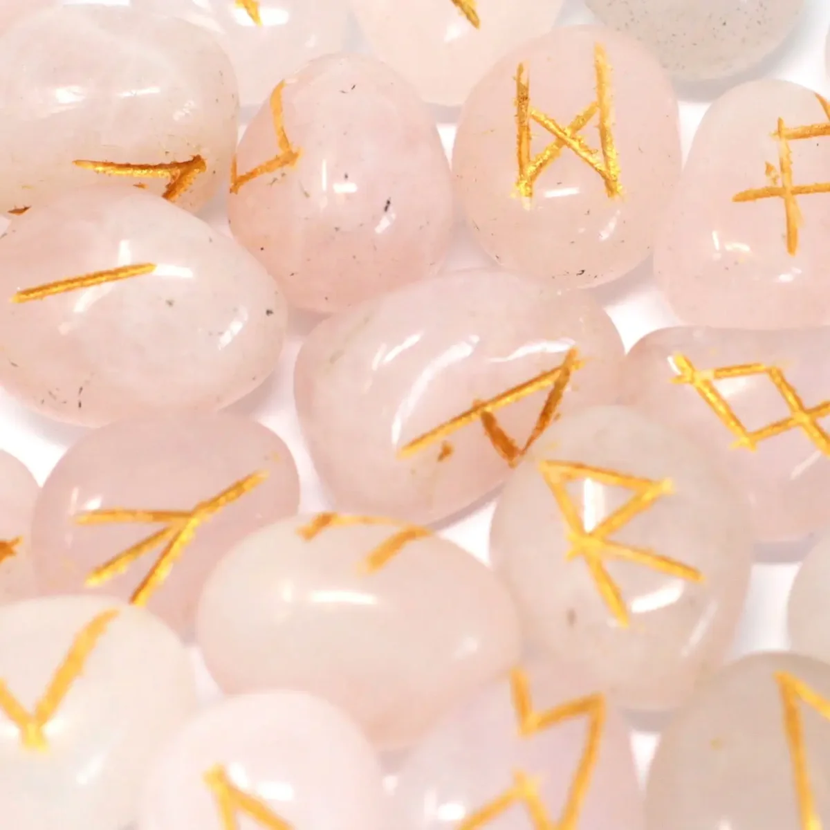 Rose quartz runes set inside a fabric pouch, showing polished stones with engraved runes visible