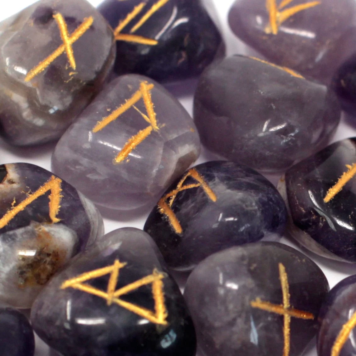Amethyst gemstones set in pouch, runes set in pouch, displayed on a plain background