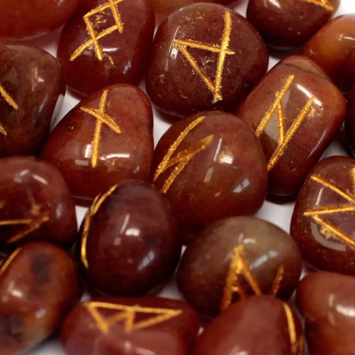 Set of red aventurine runes in a small pouch, visible on a plain background.