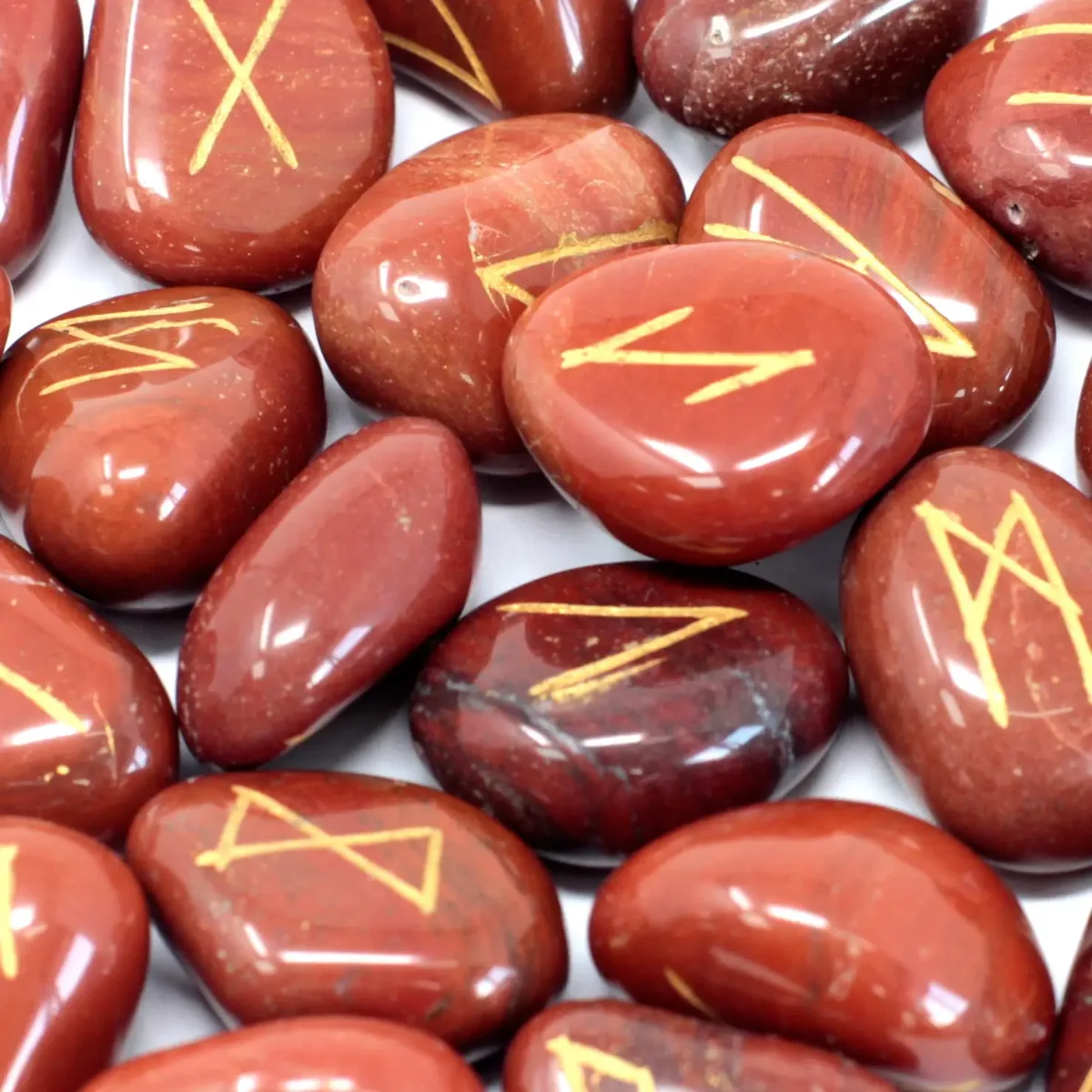 Red jasper rune stone set neatly displayed in a pouch.