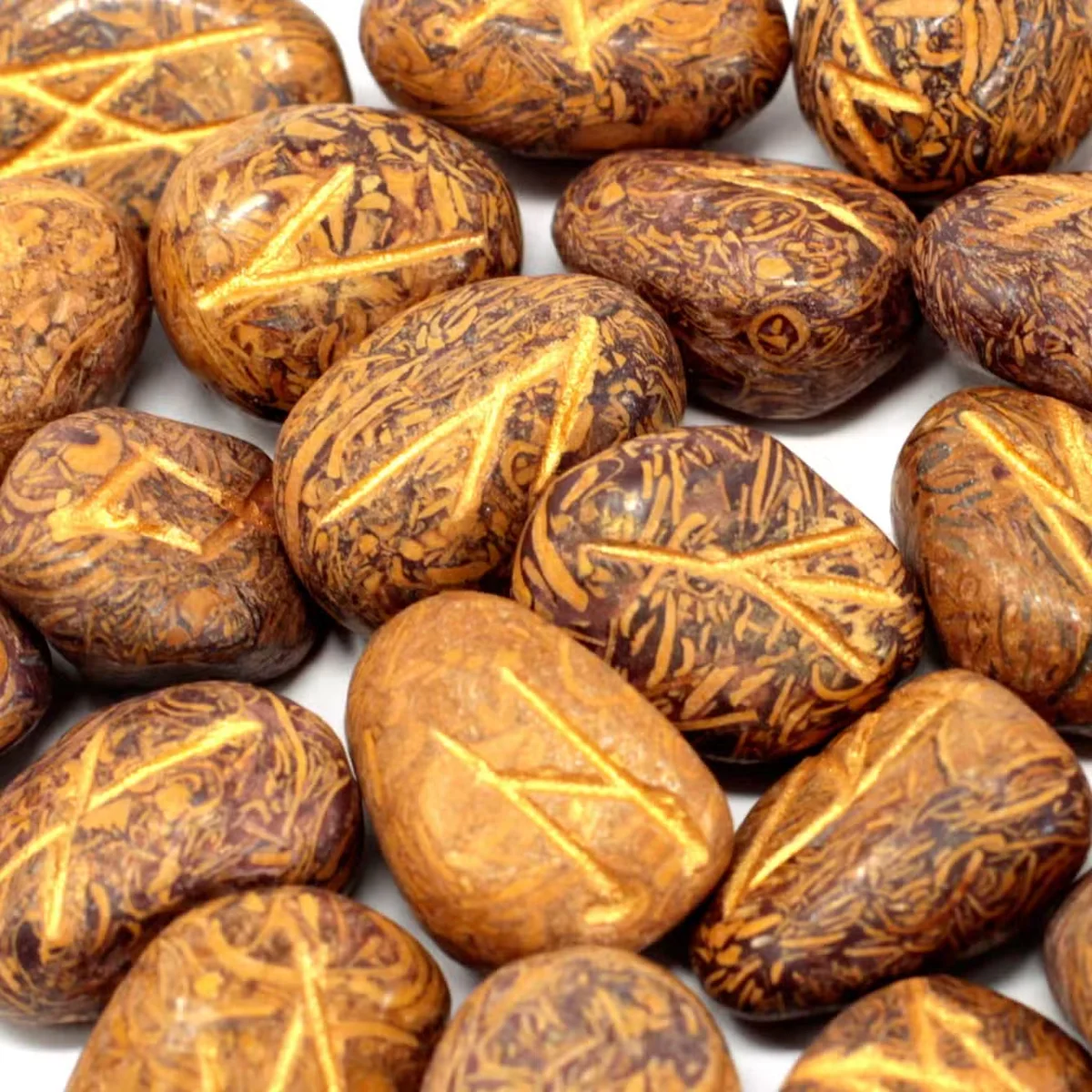 Pouch holding a jasper rune set featuring snake‑patterned stones arranged inside