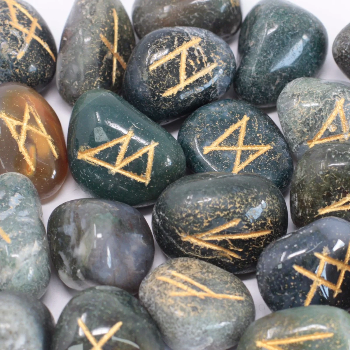 Set of moss agate rune stones in a small pouch