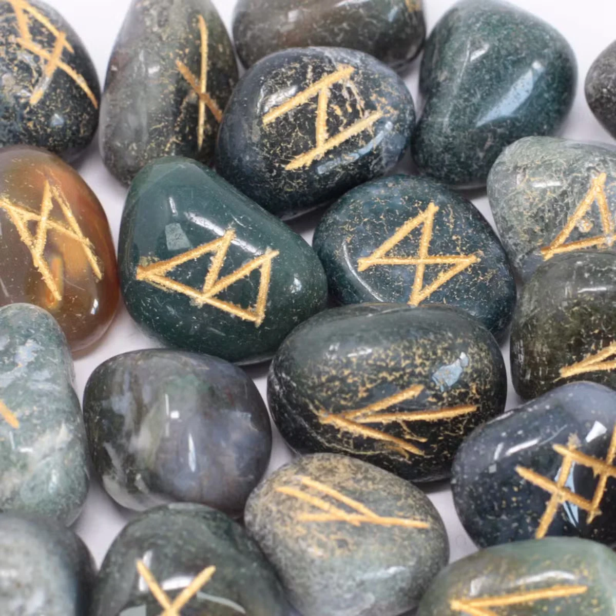 Rune stone pouch featuring moss agate stones arranged in a decorative set
