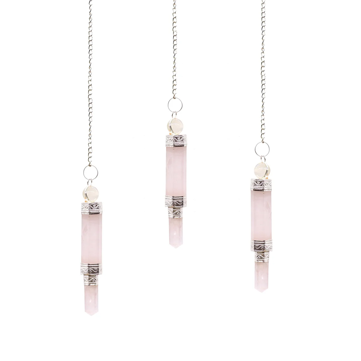 Rose quartz pendulum, a rose quartz divination tool, hanging on a fine string ready for use.