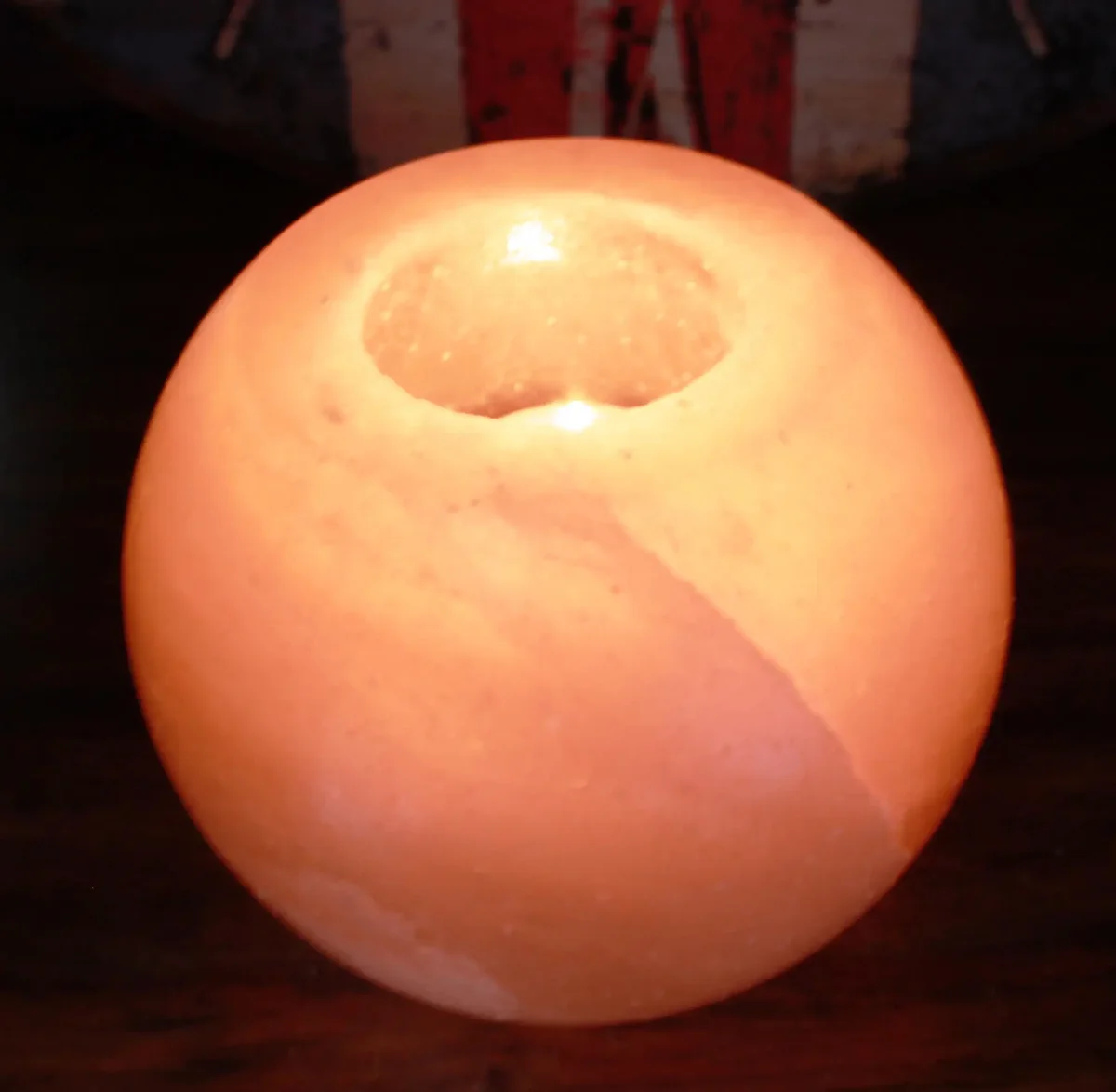 Round salt candle holder, a smooth white ceramic base for holding a candle.
