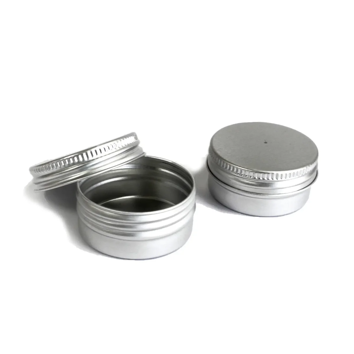 Stack of aluminium tins, 38mm by 19mm, metal containers on white background