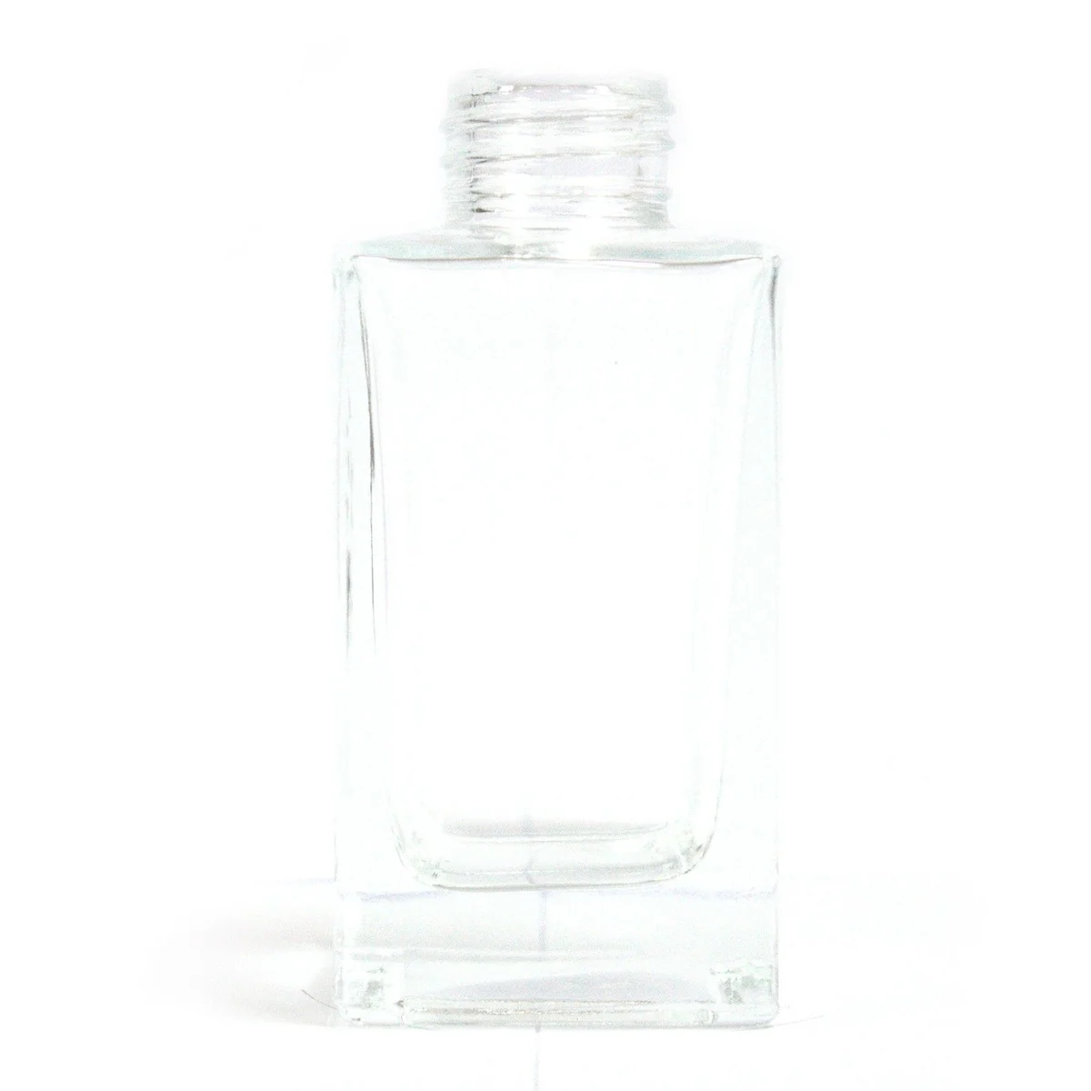 Clear, 100 ml square reed diffuser bottle displayed in a long, slender glass shape.