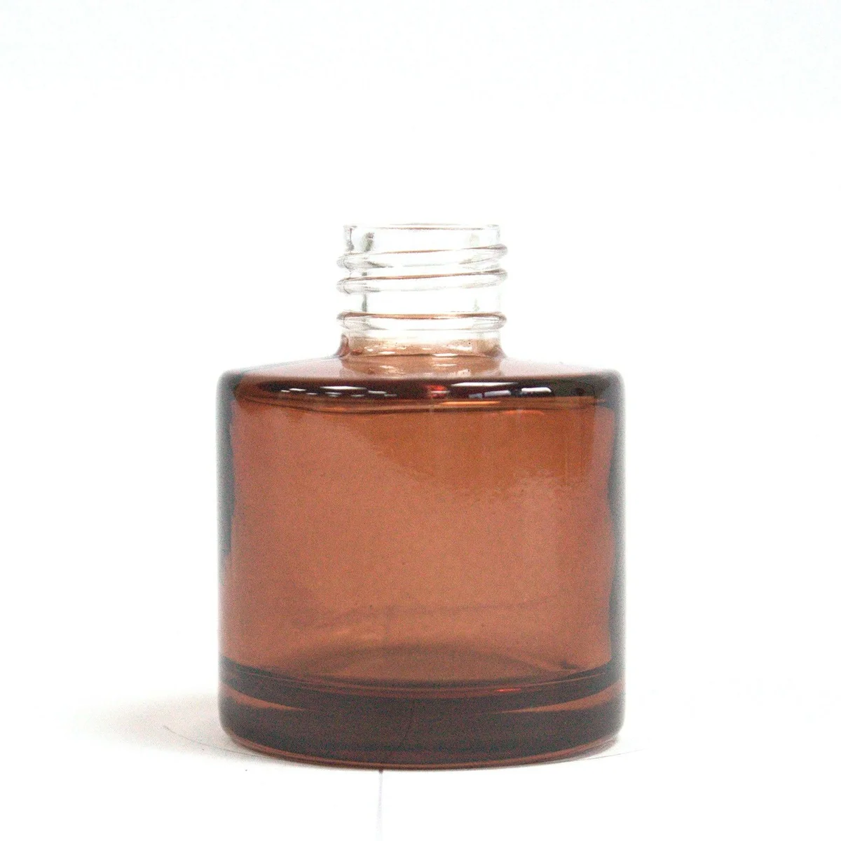 50 ml amber round reed diffuser bottle with a screw cap on a white background