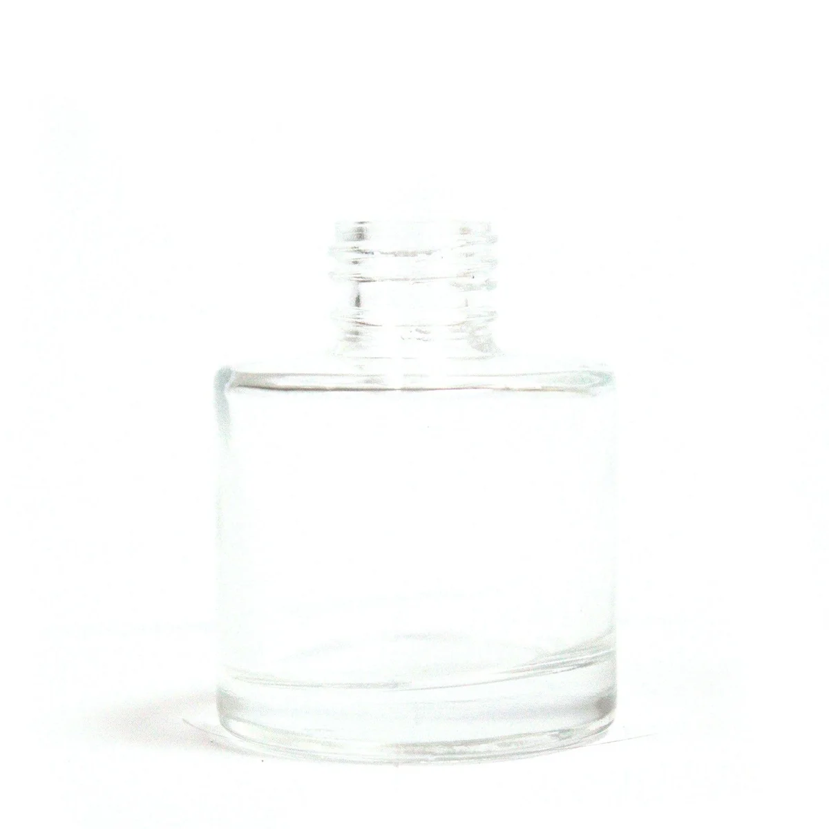 Clear 50 ml round reed diffuser bottle with smooth surface and narrow neck for essential oils or fragrance reeds