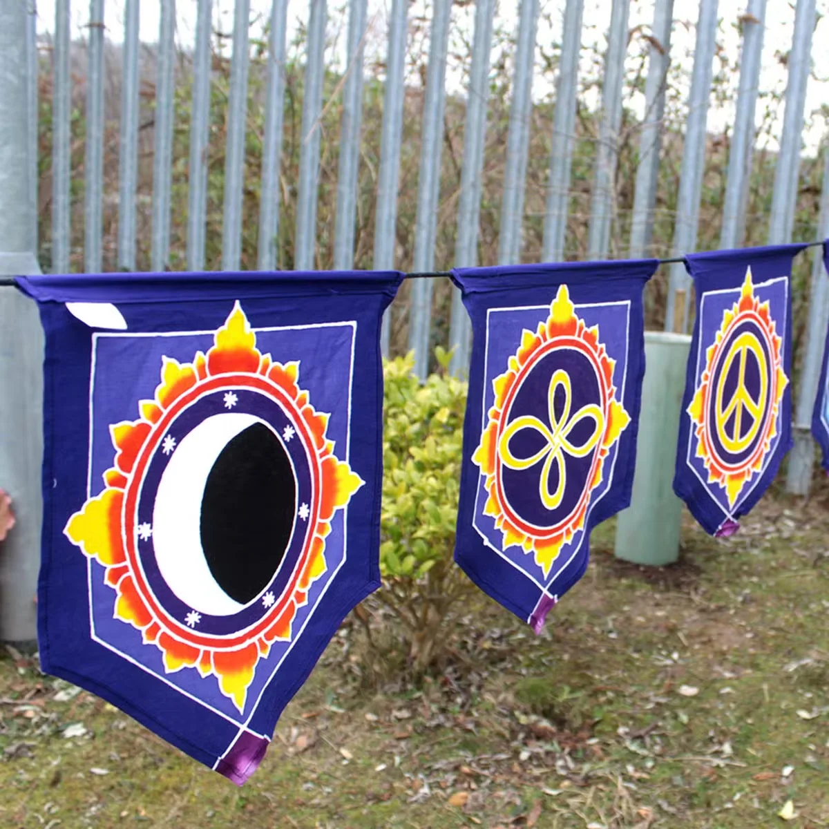 Seven colorful wall hanging flags arranged in a banner with "Love" in the center flag design