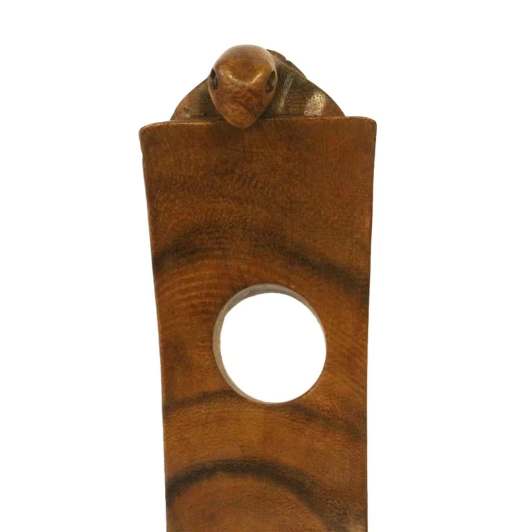 Balance wine holder in turtle design on a tabletop.