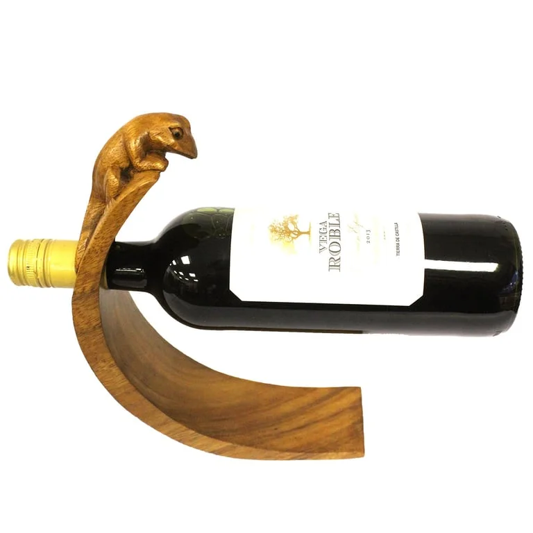 Gecko wine holder balanced on a glass cup, featuring a charming gecko-shaped holder seen in a product photo.