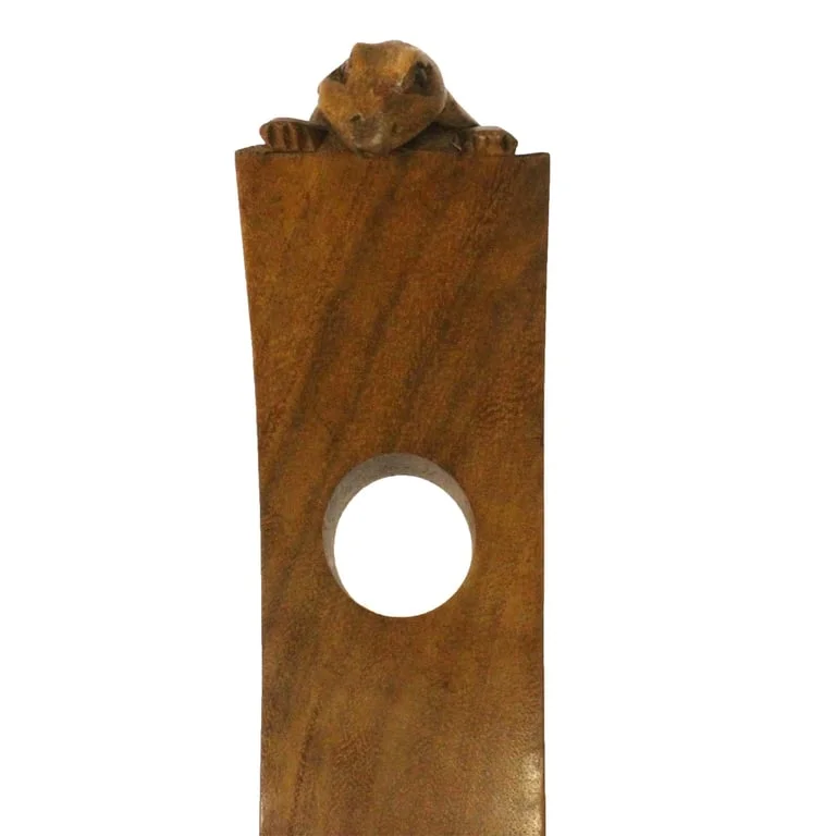Wine holders gecko displayed beside a wine bottle on a table.