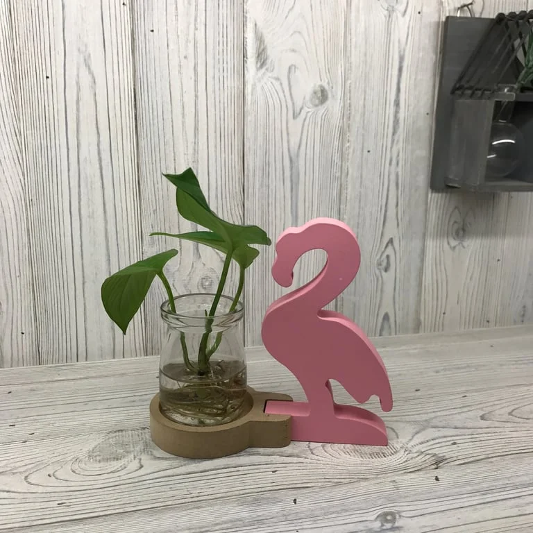 Pink flamingo pot featuring a clear hydroponic reservoir and plant support design.