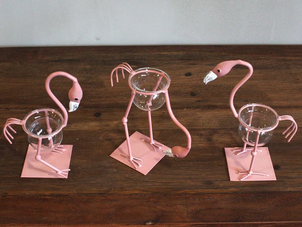 Pink metal flamingo figurine, decorative home decor accessory.