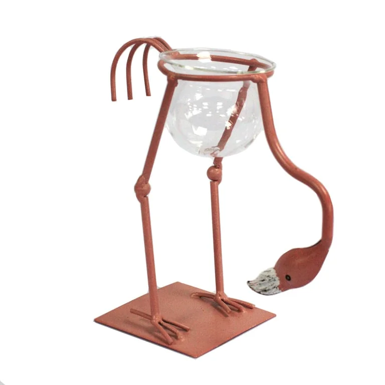 Pink metal flamingo figurine displayed in a hydroponic planter.