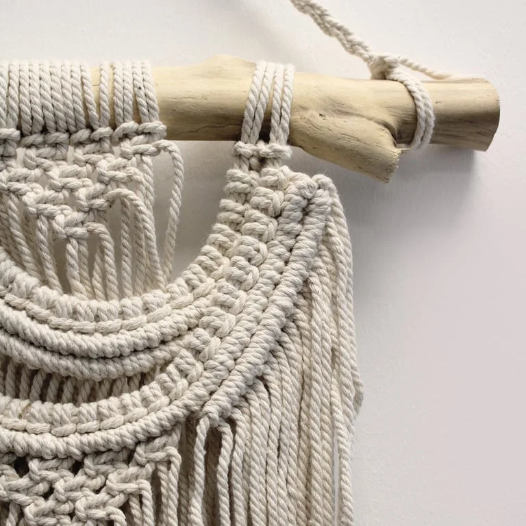 Boho wall hanging featuring two wave‑shaped macrame patterns in natural brown knots