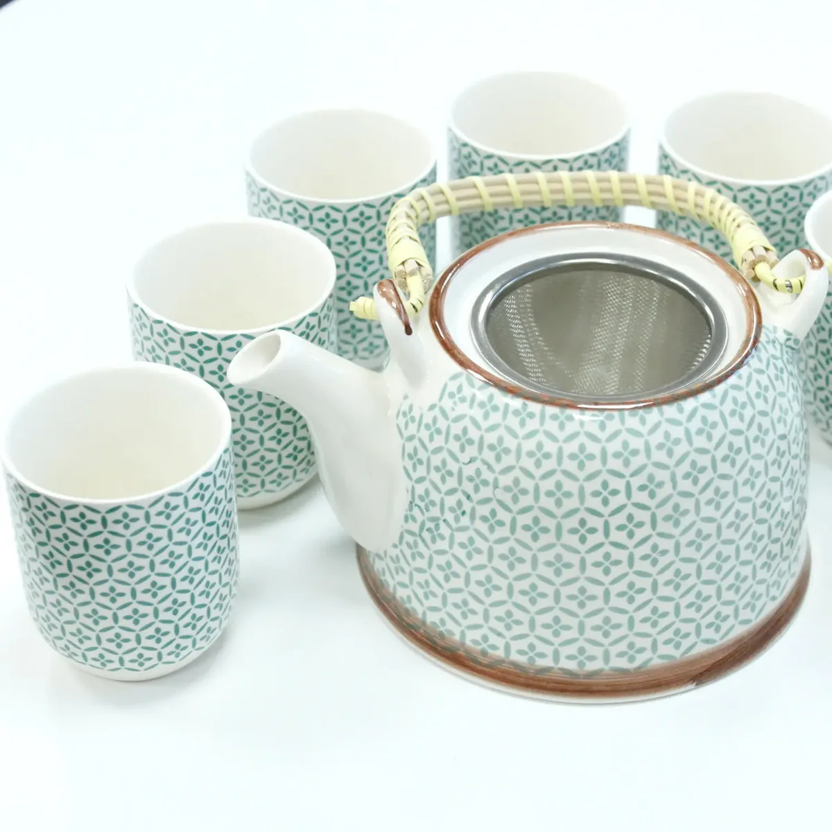 Green mosaic teapot set featuring a green ceramic teapot with mosaic pattern, matching saucer and steeping infuser.