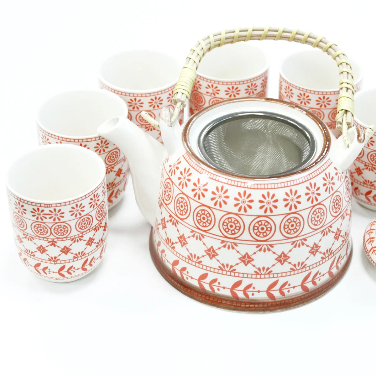 Amber herbal tea pot set with matching teapot and cups on a white background
