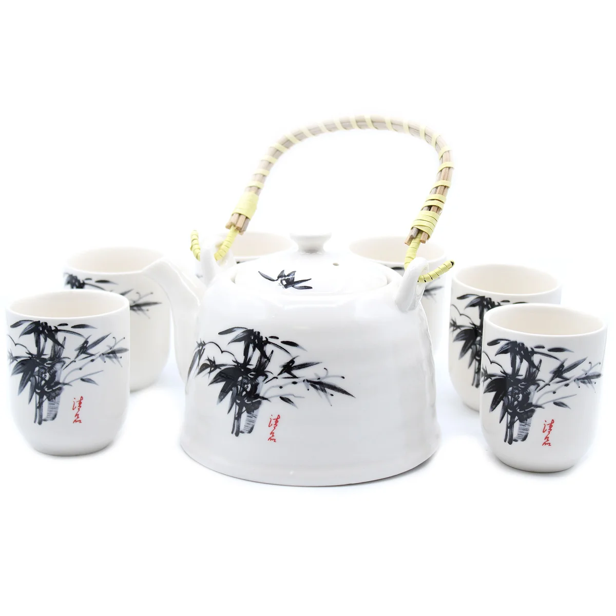 White stone oriental teapot set with matching cup and tray on a wooden surface, showcasing elegant design details