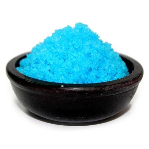 Container of baby powder simmering granules with white granules visible against a plain background