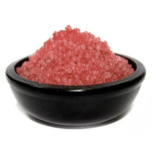 Dragons blood granules in a clear glass jar, with visible small red granules.