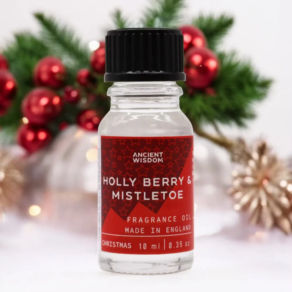 10ml amber glass bottle of Holly Berry & Mistletoe holiday essential oil with a dark label
