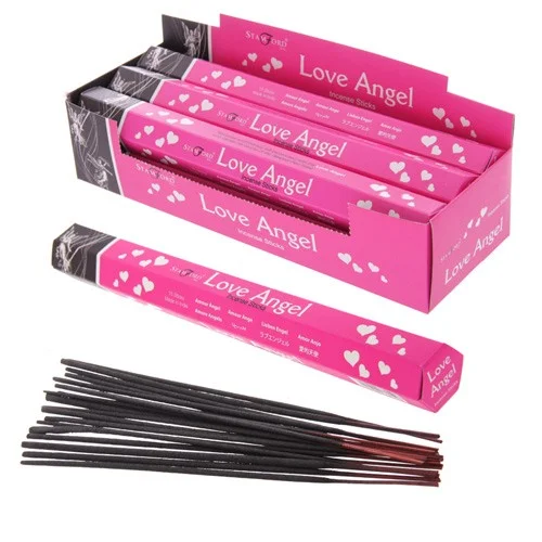 Love incense sticks displayed on a wooden tray, each slim with a white label – incense sticks UK