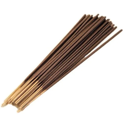 Stack of slender incense sticks wrapped in brown paper, displayed atop a wooden table, representing bulk sandalwood incense.