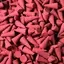 Bulky stack of fragrance incense cones, each coated in Dragons Blood scent, displayed on a neutral background.