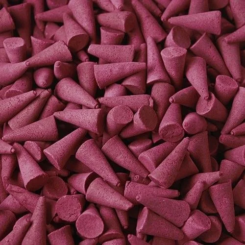 Stack of bulk strawberry incense cones displayed on a plain surface.