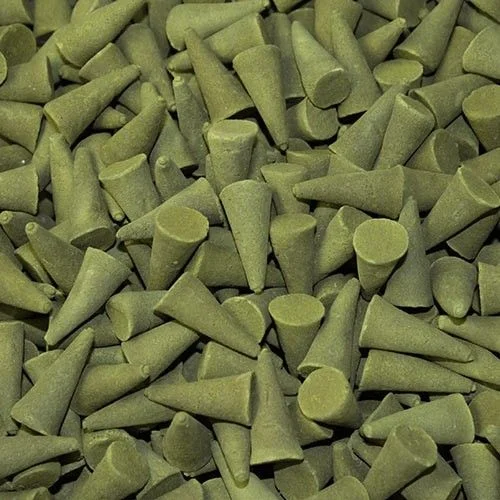 Group of bulk incense cones in tulsi basil scent, arranged on a flat surface.