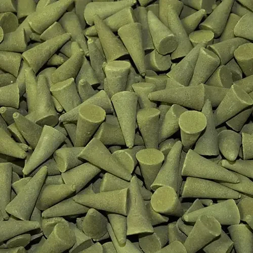 Handmade tulsi basil incense cones displayed in bulk, arranged neatly on a flat surface.