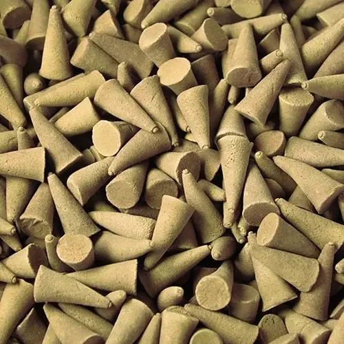 Bulk incense cones in coconut fragrance, displayed in a stack.