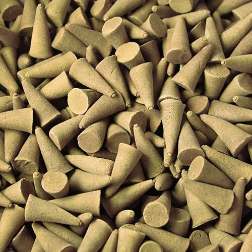 Coconut scented incense cones arranged in a bulk stack, each cone tapered and light brown.