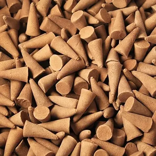 Piles of bulk incense cones in soft peach and mango hues, neatly stacked in a transparent package