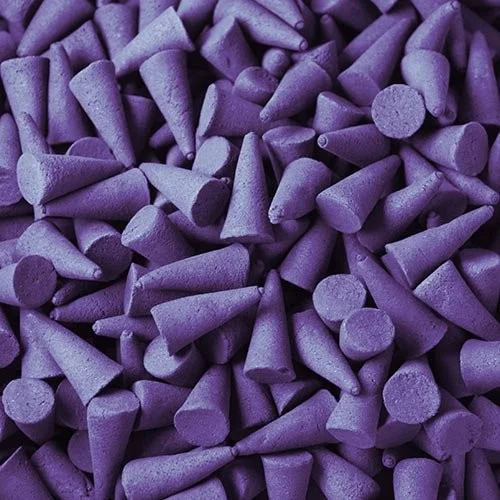 Violet incense cones arranged in bulk.