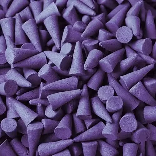 Bulk violet scented incense cones in a stack.