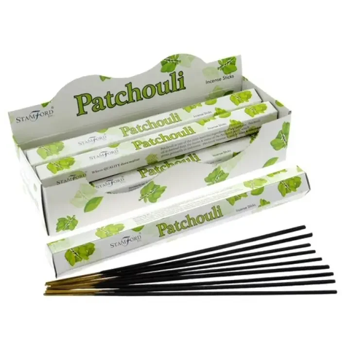 Pack of Patchouli premium incense sticks lying flat on a wooden platter