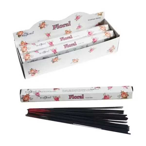 Floral scented incense sticks arranged on a pastel wood tray.
