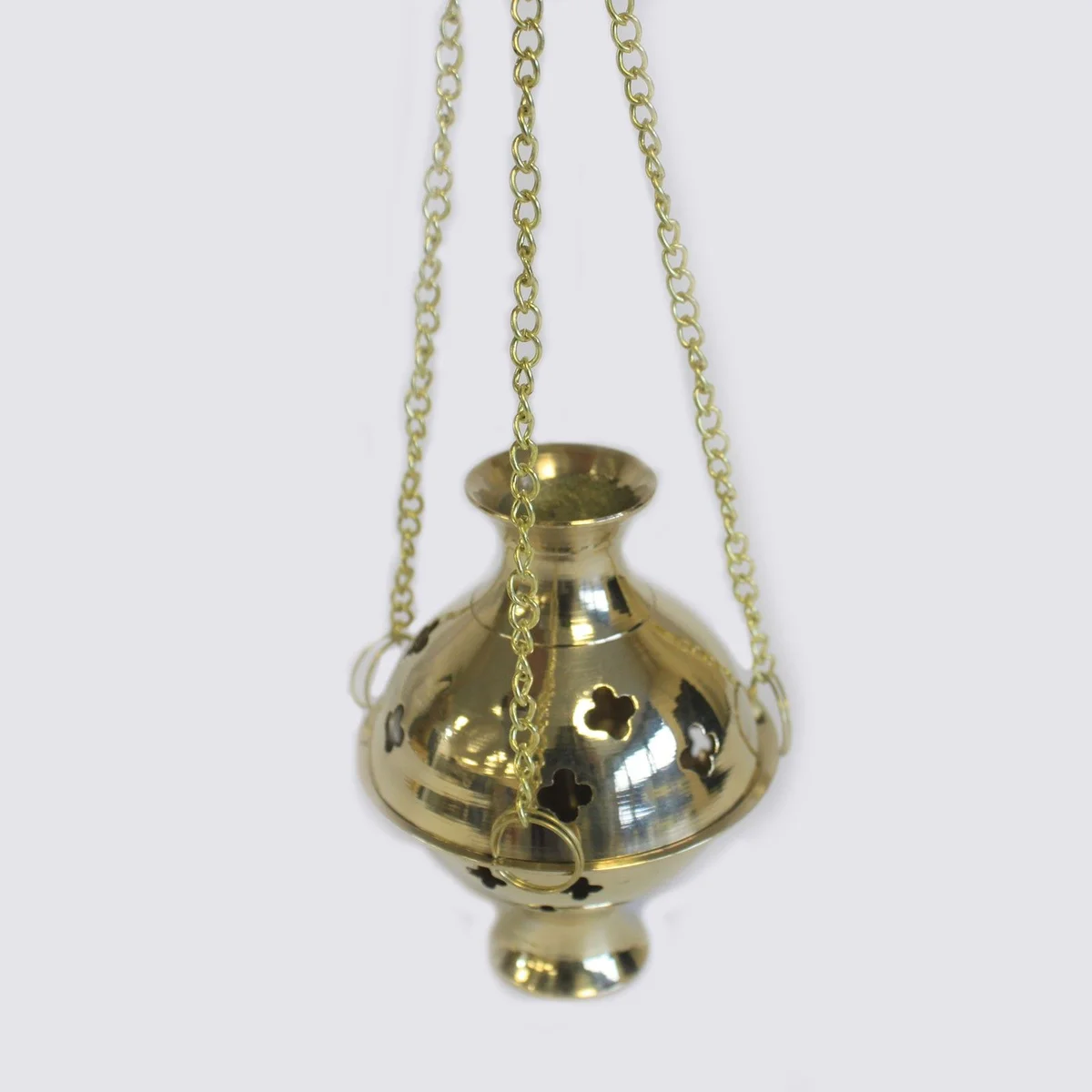 Brass incense burner hanging by a thin cord, featuring a cylindrical metal body with a decorative base and open top.